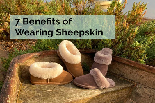 7 Benefits of wearing sheepskin | Tessie Clothing Chestnut Brown Sheepskin slipper boots and truffle sheepskin slipper mules in an old boat in Wells next the sea looking out at wells quay.