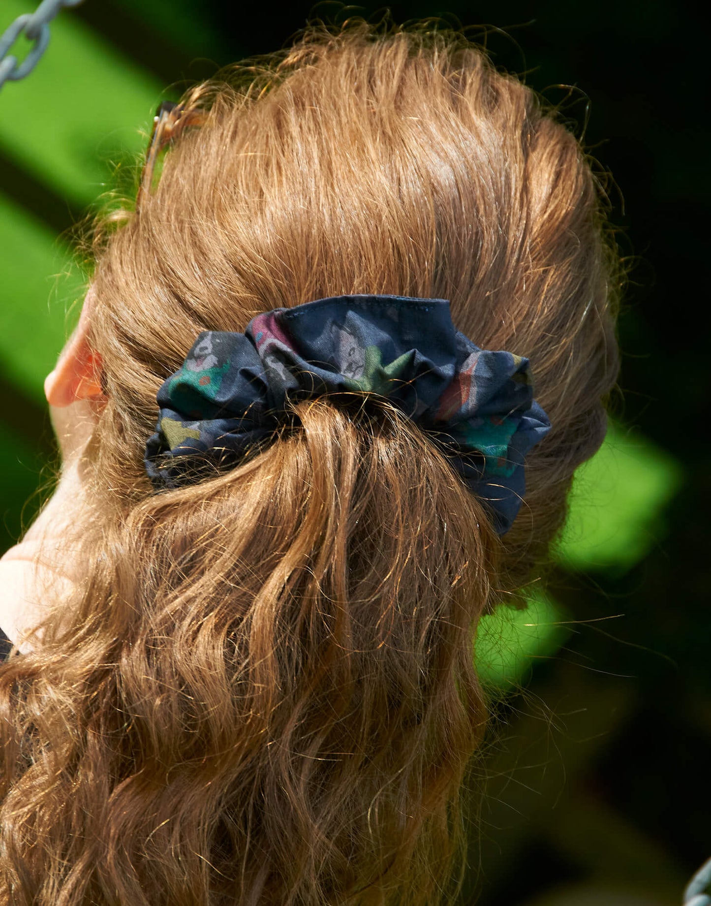 Tessie Clothing | Rascal Dog Liberty Print Hair Scrunchie | Hair Tie | Dog Hair Tie | Lifestyle shot of liberty print hair scrunchie in curly red hair tied up